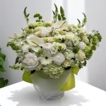 Luxury white flower bouquet featuring mums, snapdragons, and lisianthus