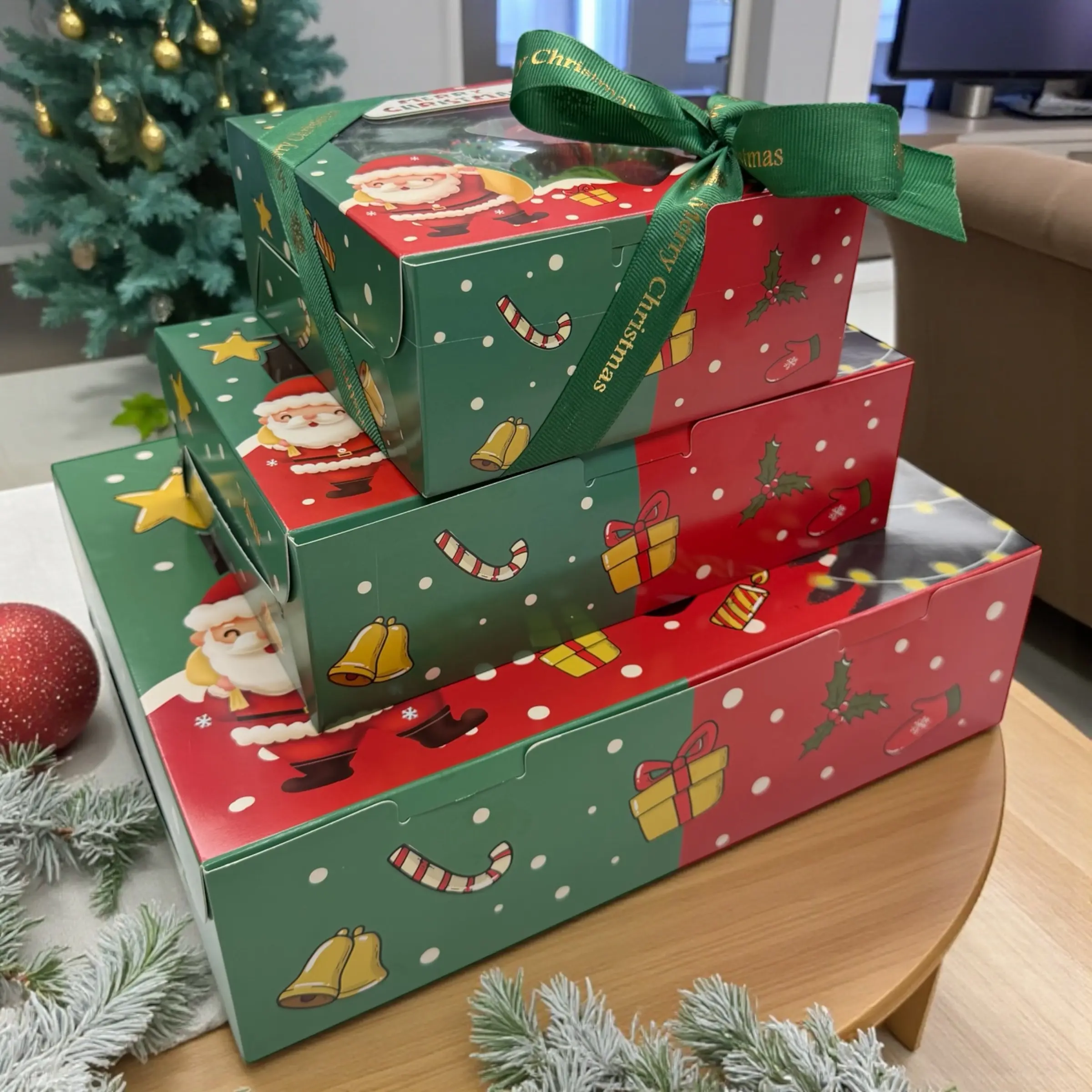 Closed Christmas macaron and chocolate strawberry gift box with Santa print and green ribbon Festive WOWBouquet dessert box with Santa themed packaging and green ribbon