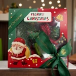 Christmas macaron and chocolate strawberry gift box placed under Christmas tree with lights