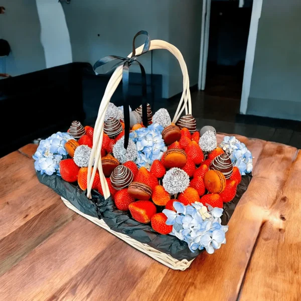 Blue hydrangeas combined with fresh strawberries, chocolate covered strawberries, and macaroons in a beautiful gift basket