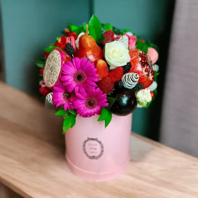 Assorted fruit gift box with Gerbera flowers and sweet treats