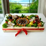 Premium fruit gift box with a selection of exotic fruits, chocolate-covered strawberries, and macaroons