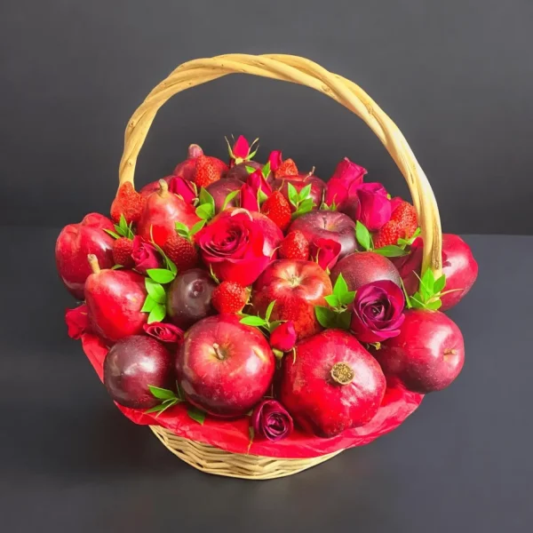 New York-inspired fruit gift basket filled with fresh apples, plums, strawberries, pears, pomegranate, and red roses.