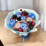 Luxurious bouquet combining blue hydrangeas and fresh fruits