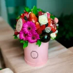 Beautiful Fruit Gift Box with fresh fruits, macarons, and Gerbera flowers