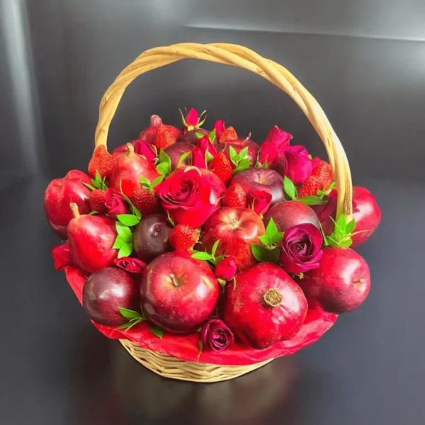 Elegant fruit gift basket featuring apples, plums, strawberries, pears, pomegranate, and beautiful red roses.