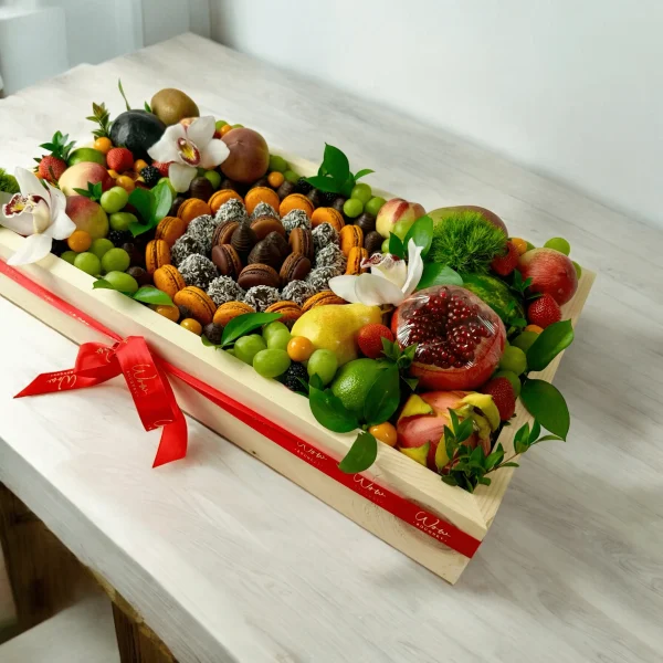 Sophisticated fruit gift box featuring exotic fruits, chocolate-covered strawberries, and macaroons in a custom wooden box