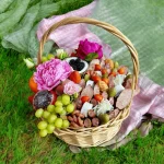 Unique gift basket containing tropical coconut, grapes, and cured meats