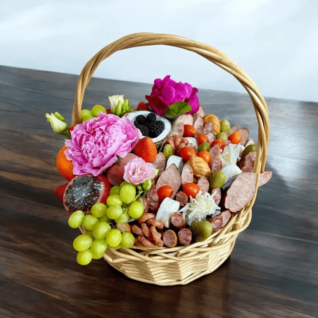 Gourmet gift basket with pomegranates, figs, strawberries, and cheeses