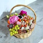 Mixed gift basket with fresh fruits and savory meats and cheeses