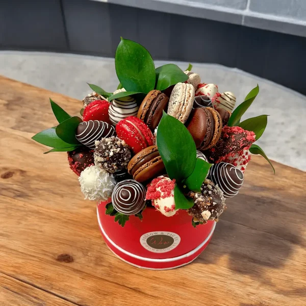 Delicious chocolate-covered strawberries and bananas with a variety of macarons