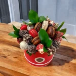 Assorted chocolate-covered strawberries, bananas, and macarons gift box