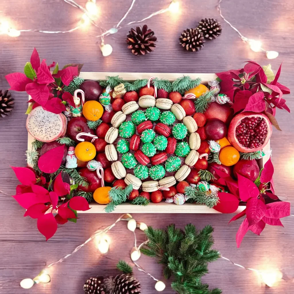 Perfect for the holidays: a Christmas Celebration Gift Box with fruits, macarons, flowers, and chocolate strawberries.