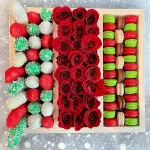 Our Sweets Box offers a combination of chocolate-covered strawberries, bananas, macarons, and roses, creating a perfect gift for any occasion.