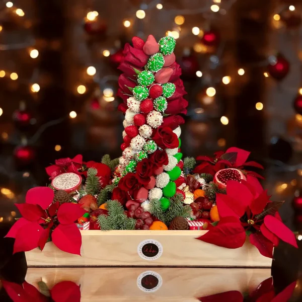 The Christmas Fruit Gift Box includes a large box filled with assorted fruits and chocolates, topped with an impressive 18-inch strawberry tower.