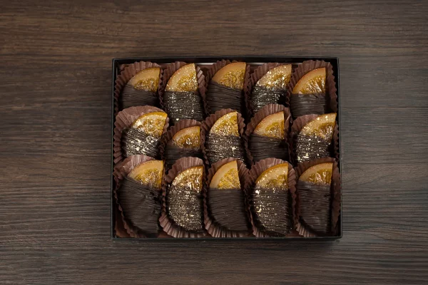 Exquisite chocolate-dipped orange slices in a gift box, offering a unique and irresistible twist on the classic chocolate orange flavor.