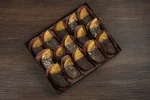 Elegant gift box filled with chocolate-enrobed orange slices, an ideal treat for those who adore the combination of orange and chocolate.
