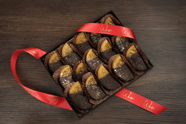 A decadent gift box featuring chocolate-covered orange slices, perfectly balancing the zesty freshness of citrus with rich dark chocolate.