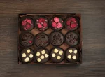 A beautifully presented box of French Chocolate Mendiants, offering a trio of chocolate varieties each with its own distinctive topping.