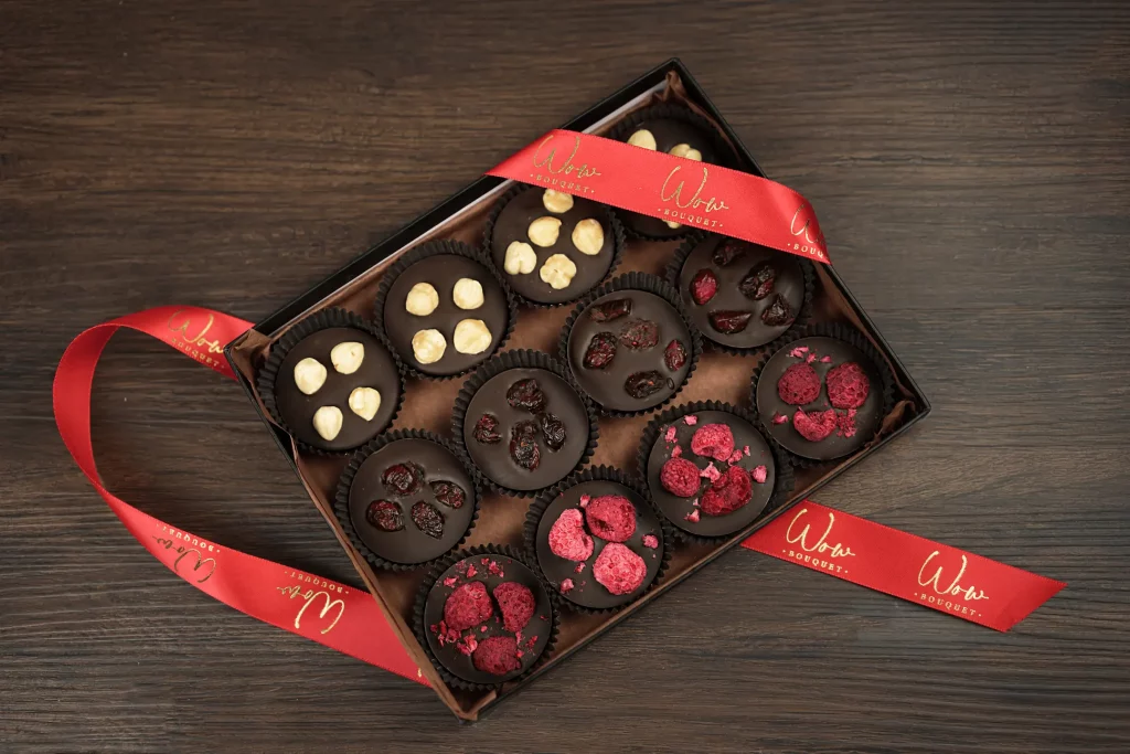 A luxurious gift box of 12 assorted French Chocolate Mendiants, blending smooth chocolate with crunchy toppings for a gourmet treat.