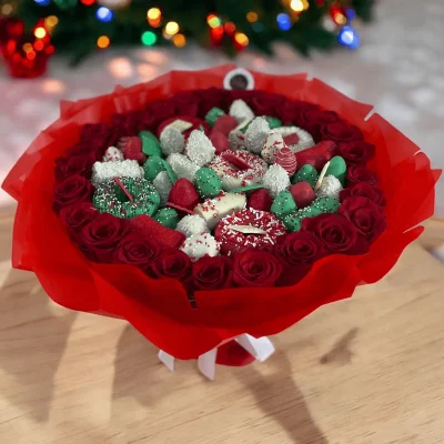 The Holiday Gift Bouquet offers a delightful mix of 2 dozen roses and chocolate-covered fruits, making it the perfect gift for festive celebrations.