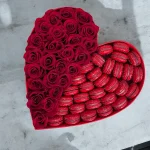 Luxurious box of red roses and a variety of gourmet macarons