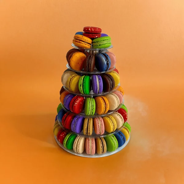 Colorful French macarons displayed in a tall, six-layer tower.