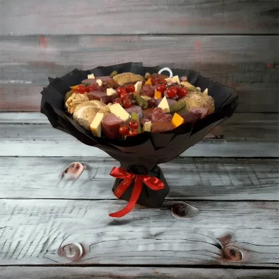 Overhead shot of a unique Father’s Day bouquet, artfully arranged with savory treats like meats, cheeses, and fresh vegetables, ideal for a dad who loves to snack.