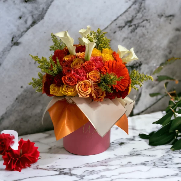 A bold and beautiful bouquet representing New York City, with a lively selection of yellow, orange, and red flowers including roses and calla lilies.
