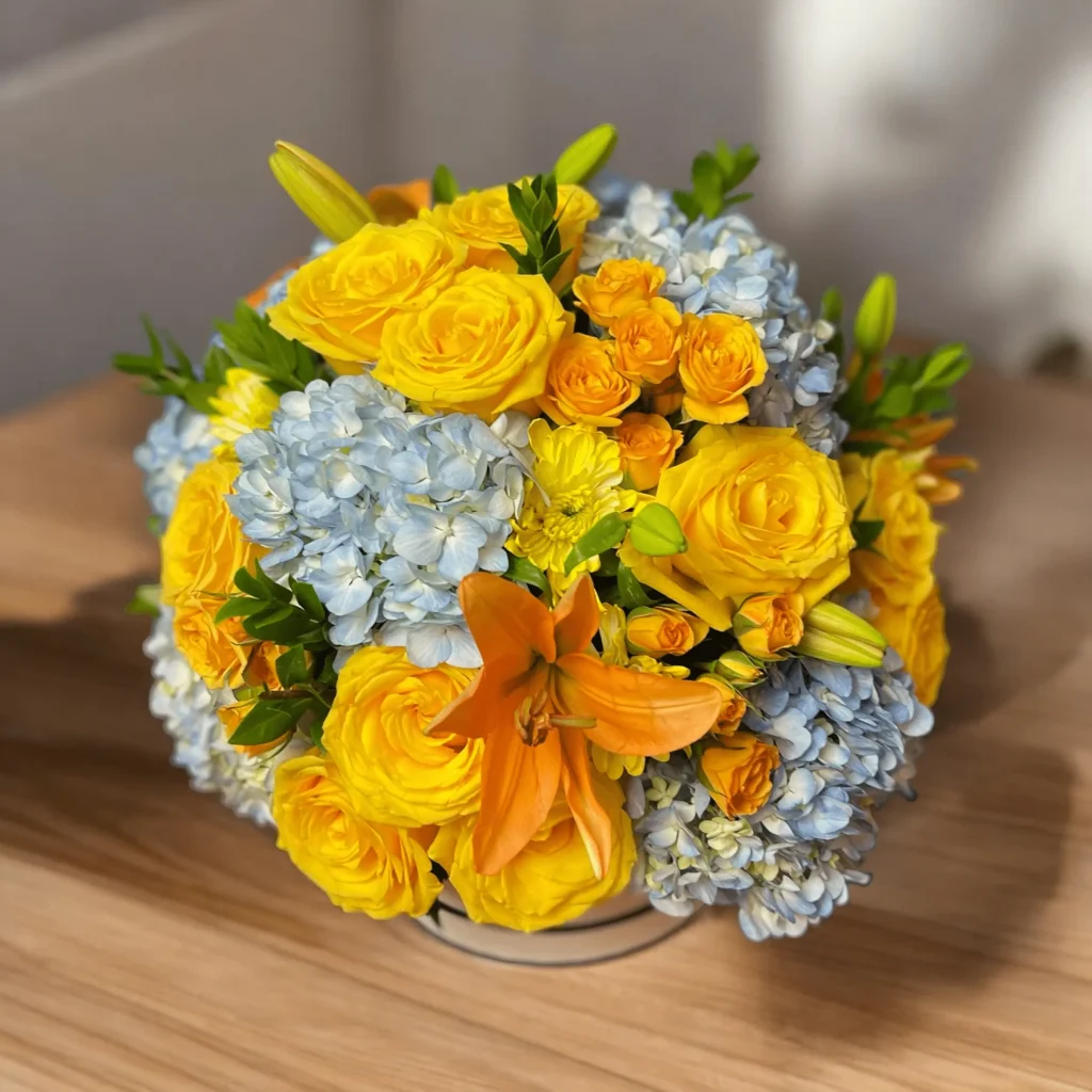 Bright and cheerful Celebration Bouquet with yellow lilies and blue hydrangeas