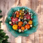 Holiday gift bouquet with fresh fruits and delicious chocolates, perfect for spreading festive cheer.