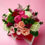Overhead shot of a luxurious floral bouquet from SOHO, blending red, pink, and white flowers like hydrangeas and spray roses, ideal for gifting or decorating.