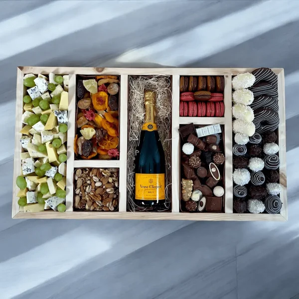 A corporate gift set featuring a diverse mix of sweets, cheeses, and chocolate-covered strawberries.