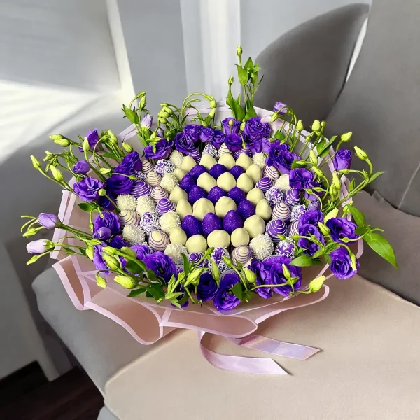 Chocolate-covered strawberries and lisianthuses in a letter-shaped arrangement