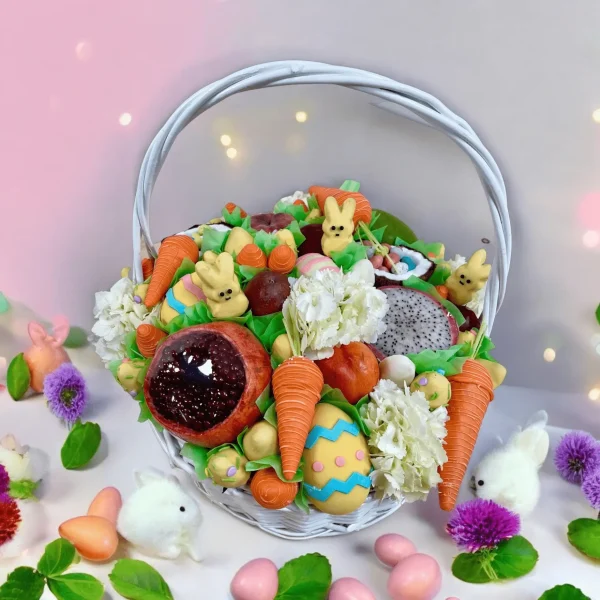 Celebratory Easter Basket with floral elements, fresh fruits, chocolate-covered strawberries, and festive carrot cake pops