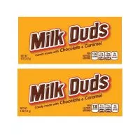 Close-up of Milk Duds candies, showcasing their round shape and caramel-filled chocolate coating.