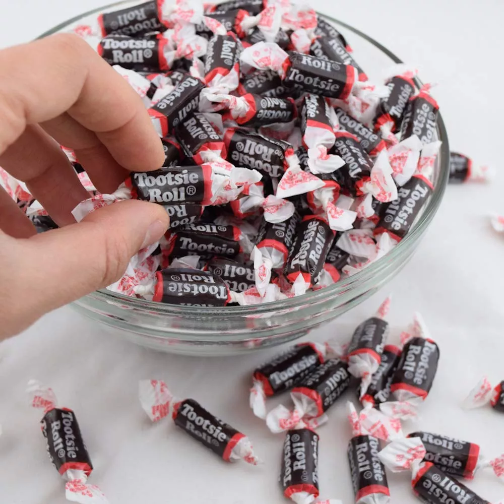 Close-up of a Tootsie Roll, showcasing its cylindrical shape and rich, chocolatey texture.