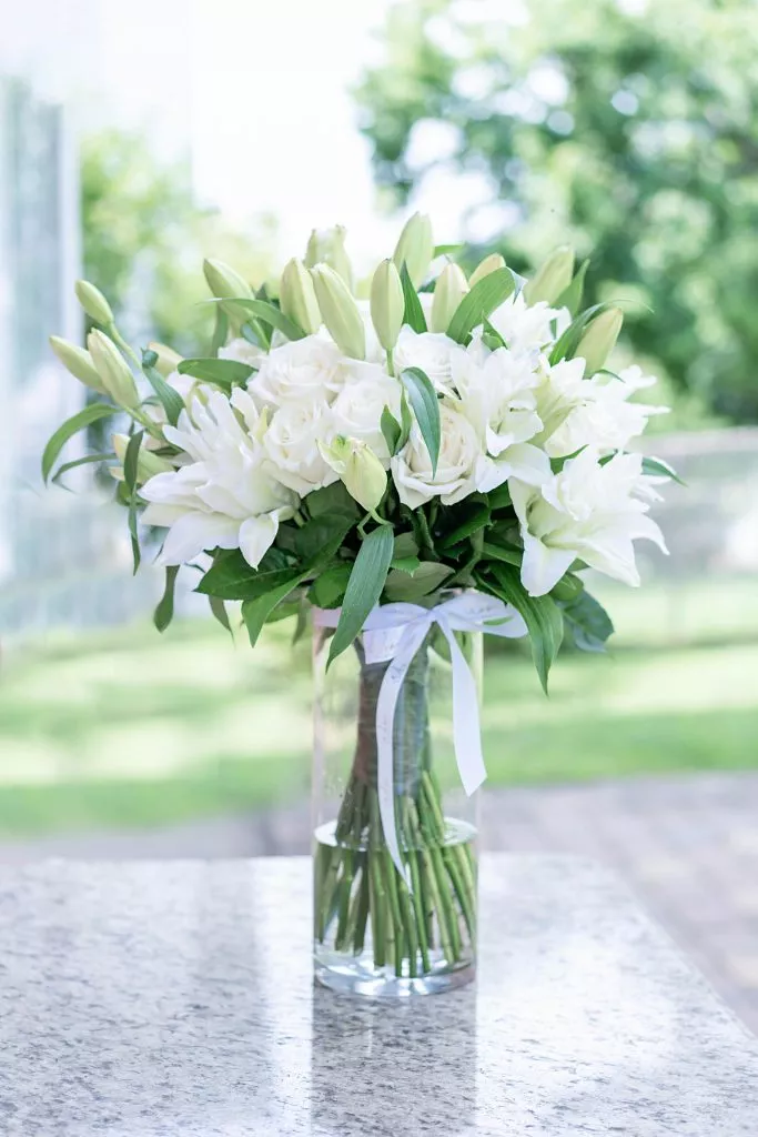 Elegant 'Pure Serenity' bouquet with white roses and lilies from NYC.