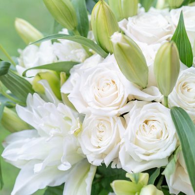 NYC's finest white rose and lily arrangement in the 'Pure Serenity' bouquet.