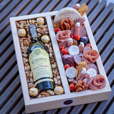 Custom wooden box filled with gourmet nuts, meats, and cheeses.