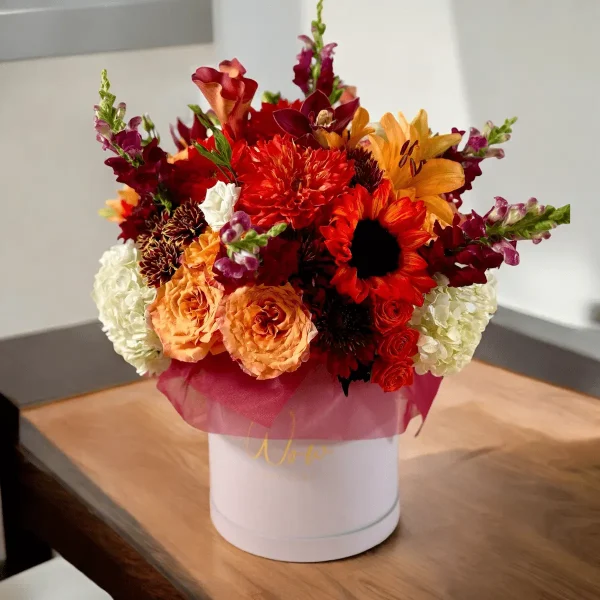 A close-up shot of a bouquet with yellow, orange, and red flowers, highlighting the intricate details of the petals.