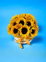 Detailed image of sunflowers in a hatbox, focusing on the textures and rich colors of the flowers that make it a perfect centerpiece.