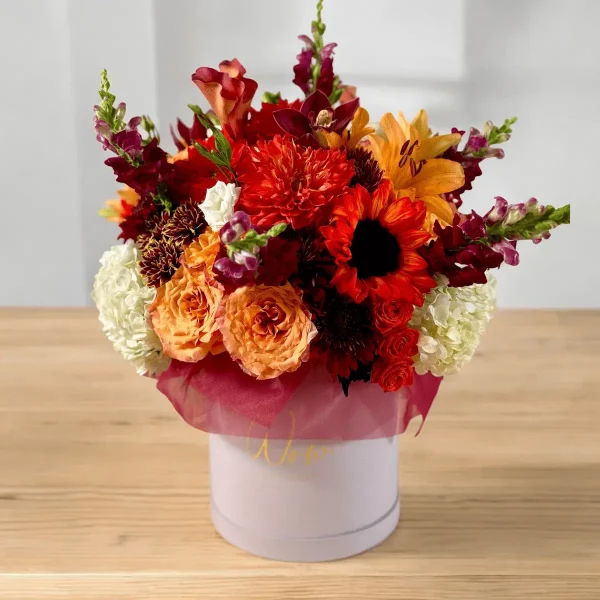 A cozy autumn flower arrangement in warm colors, featuring seasonal blossoms