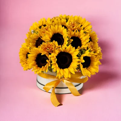 A beautifully arranged hatbox with 40-50 sunflower stems, capturing the essence of summer and joy in a compact floral display.