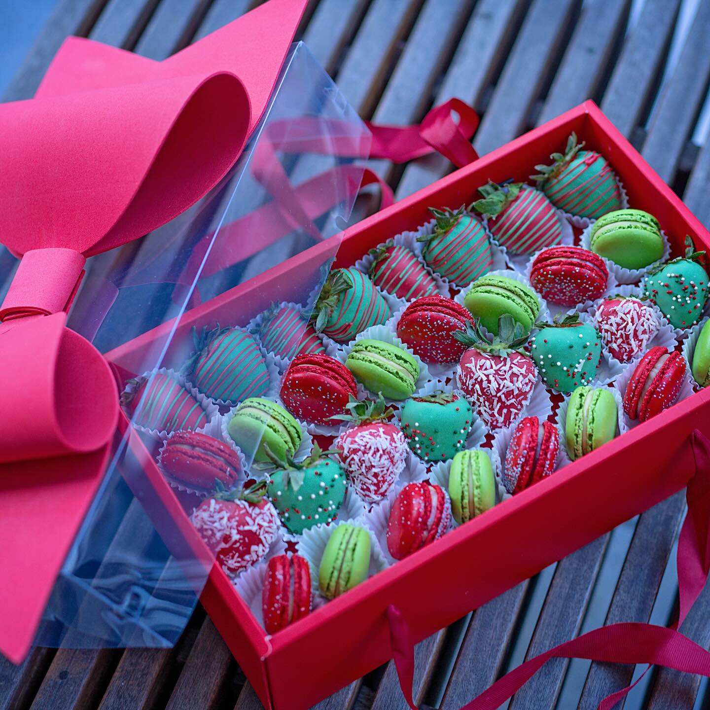 A festive tin of beautifully decorated Christmas cookies featuring snowflakes, reindeer, and holiday-themed designs, perfect for gifting.