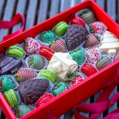 Winter Wonderland Box with chocolate-covered strawberries and macarons, embodying NYC's Christmas spirit.