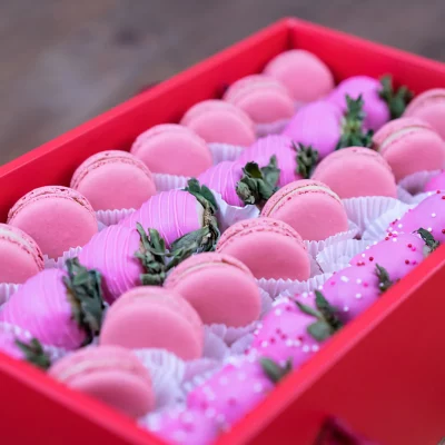 Gourmet pink strawberries and macarons in a deluxe box.