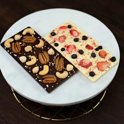 Image of WOWBouquet's duo chocolate bars: dark chocolate with nuts and white chocolate with freeze-dried berries
