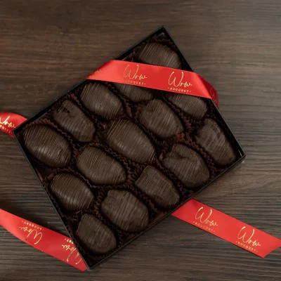 Box of gourmet chocolate covered dates, ideal for sophisticated gifting.