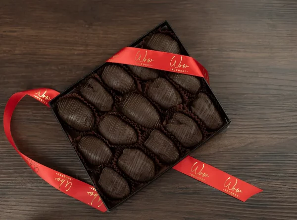 Box of gourmet chocolate covered dates, ideal for sophisticated gifting.